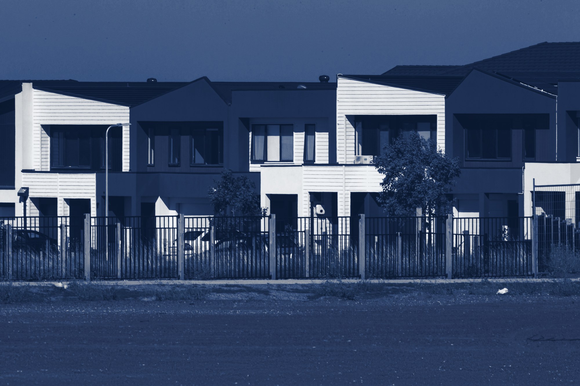 Row of new townhomes, tinted navy